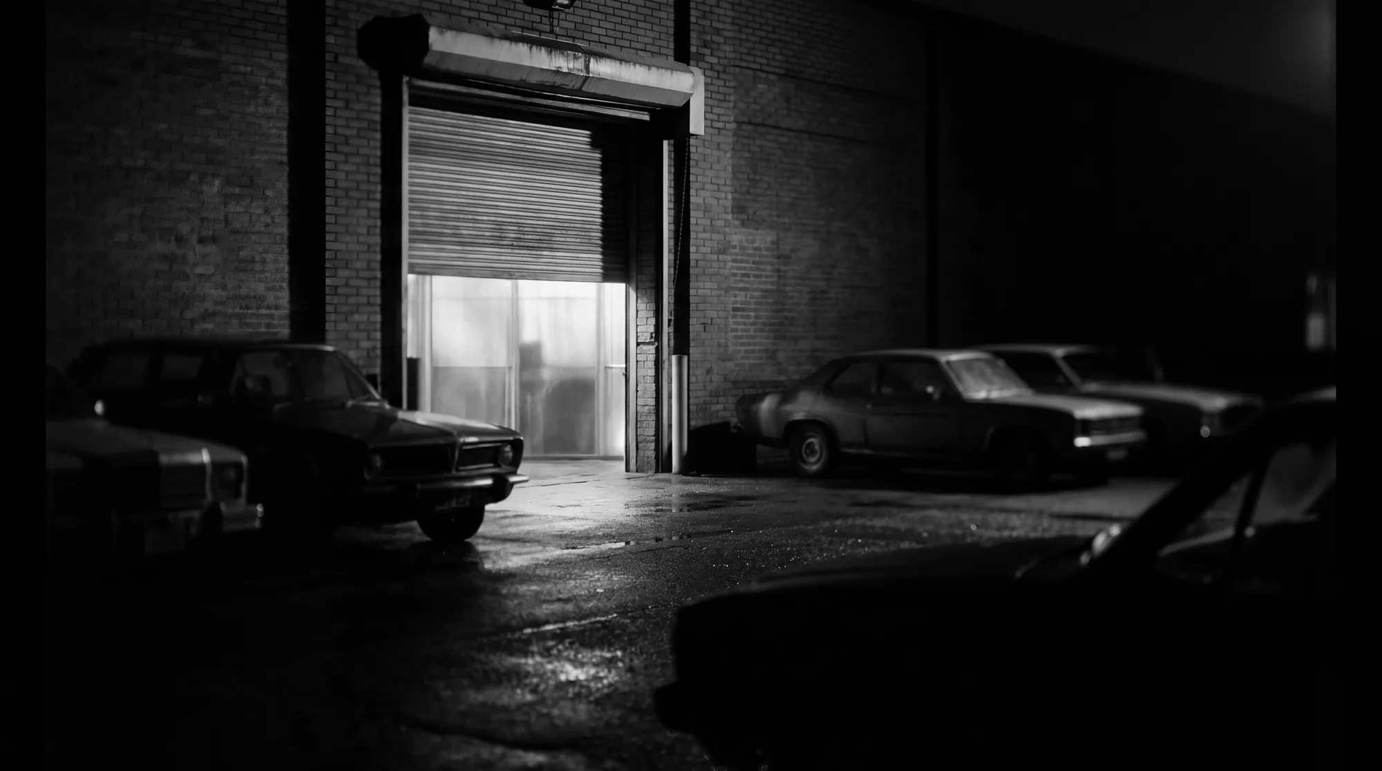 The Padel 88 entrance at night, light spilling onto the car park.